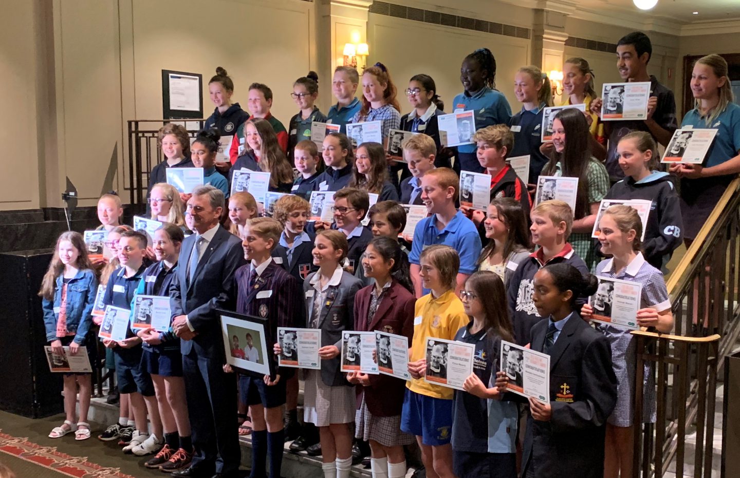 Junior Ambassador, Cam, with Chair of The Fred Hollows Foundation, John Brumby and award recipients.