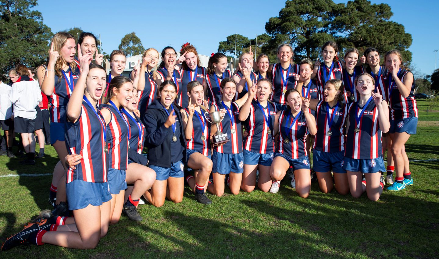 Jemma and the team celebrating with the ACS Senior Girls Football trophy